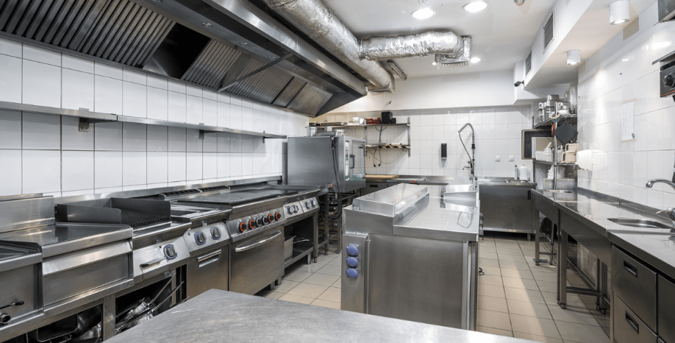An industrial kitchen with recessed downlights 